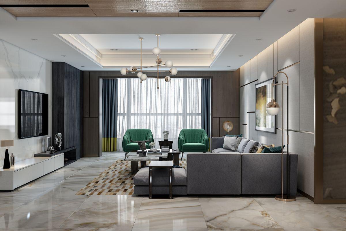 Modern living room with gray sectional sofa, green armchairs, and stylish decor under a chandelier.