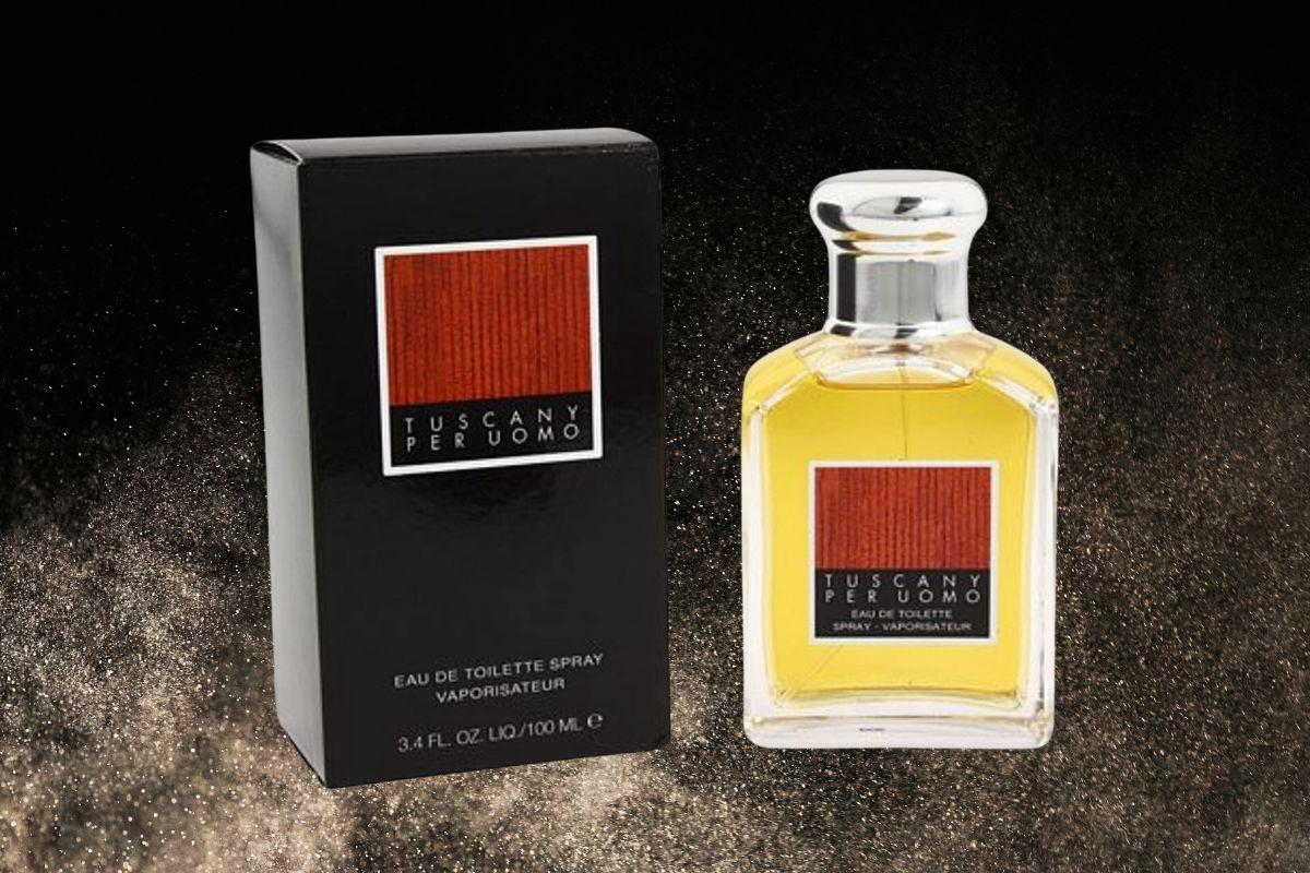 Tuscany Per Uomo cologne bottle and box displayed against a dark, textured background.