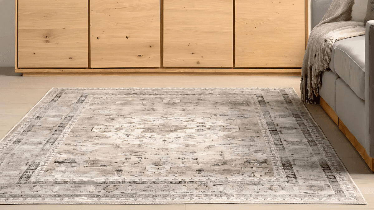 Elegant vintage-style rug with a muted, intricate pattern, adding warmth and sophistication to a cozy living room setting.