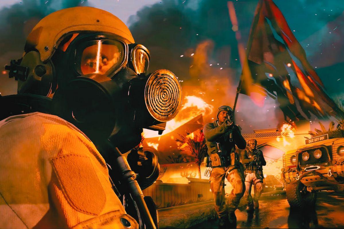 Soldiers in tactical gear and gas masks move through a chaotic battlefield with flames, smoke, and explosions in the background.