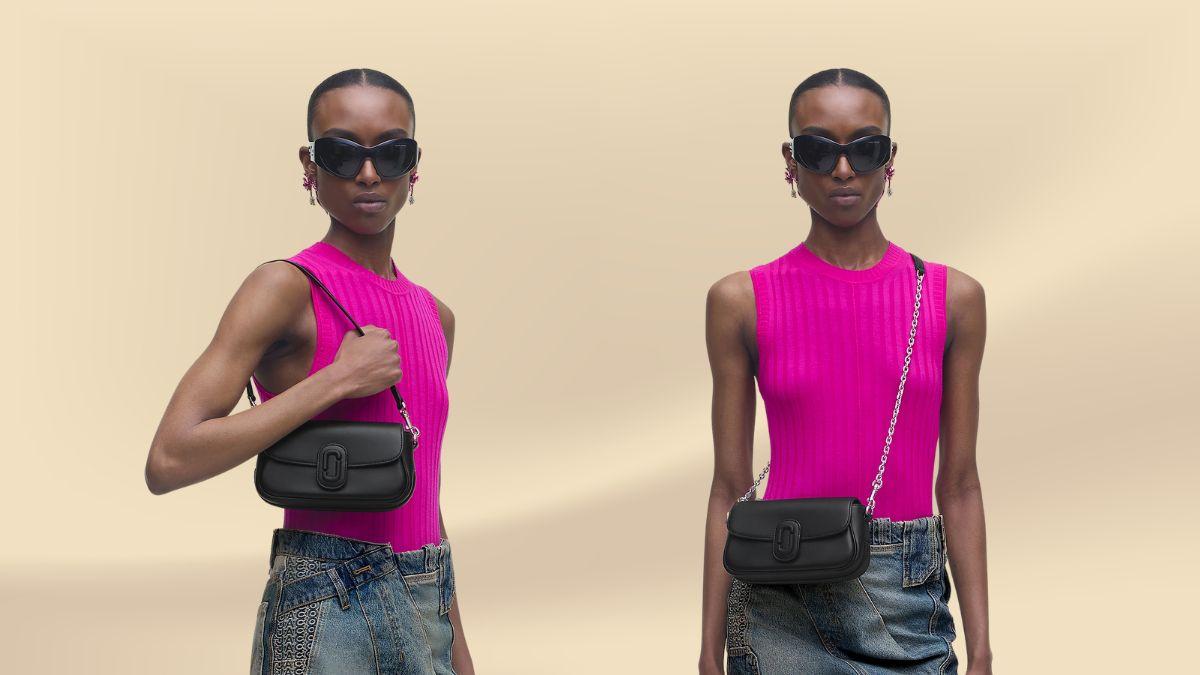 A model in a pink top and denim skirt wears a black Marc Jacobs Clover Shoulder Bag in two different ways, one with a leather strap and the other with a chain strap.