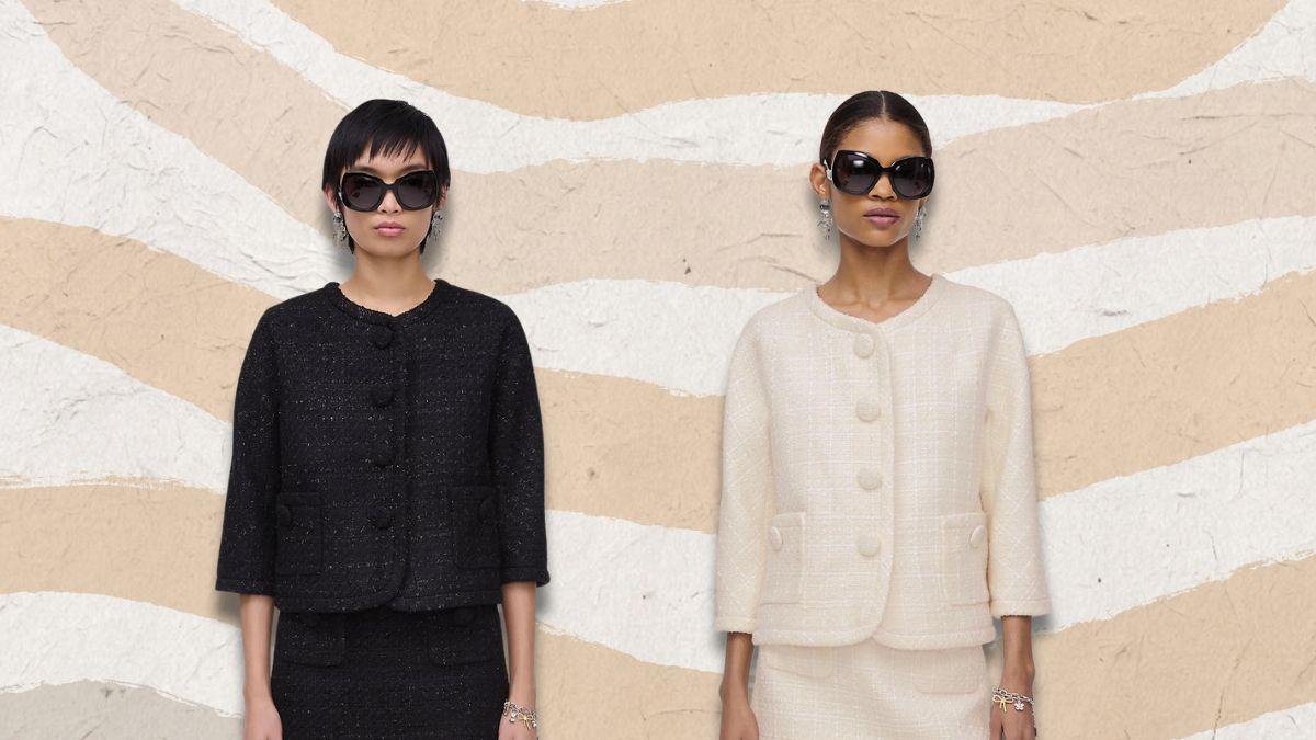 Two women wearing tweed jackets, one in black and one in white, with matching skirts, large buttons, and sunglasses, standing against a neutral wavy background.