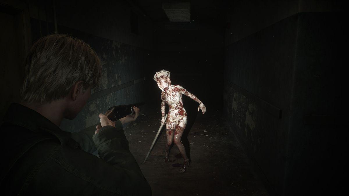 A character aims a gun at a bloody nurse-like creature in a dark, abandoned hallway.