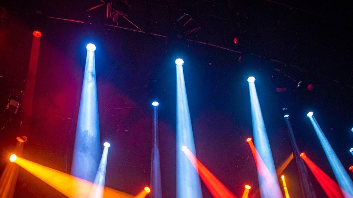 Colorful stage lights in blue, red, and orange shining across a concert venue — representing StubHub Interactive Tools and enhanced live event experiences.