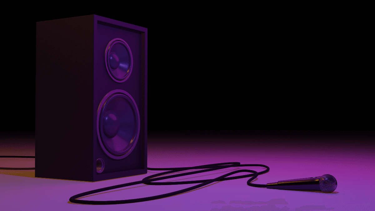 Close-up of a speaker and microphone on a gradient purple and black background, creating a dramatic and vibrant atmosphere.