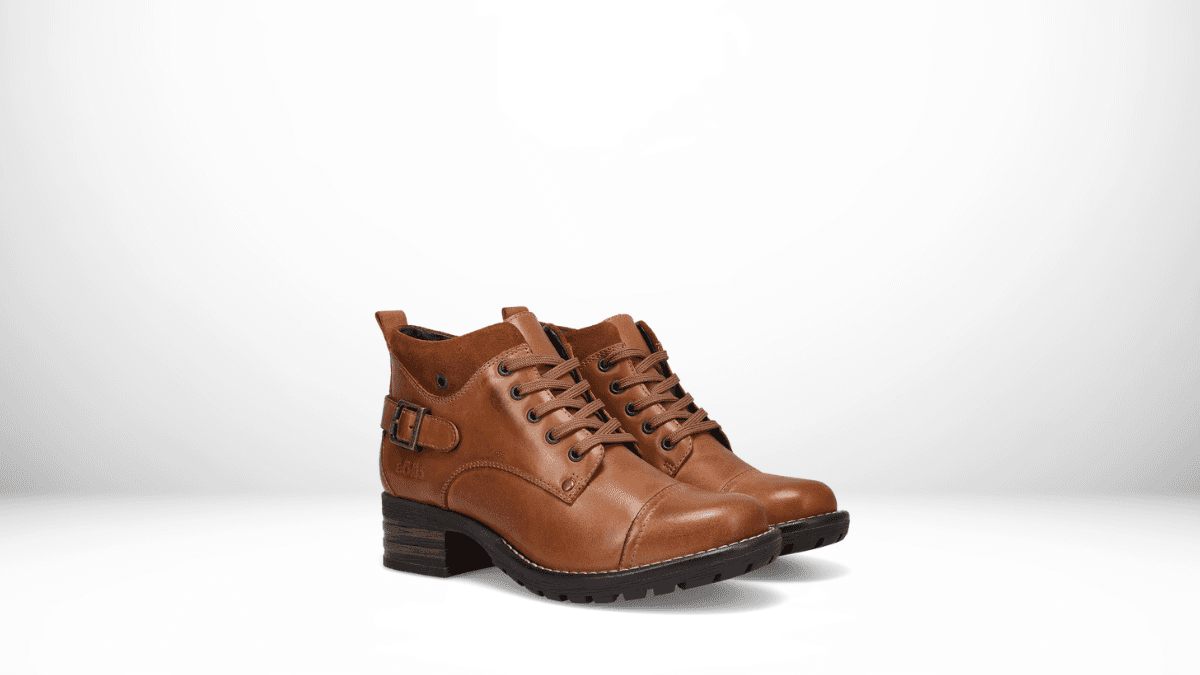 A pair of brown leather ankle boots with lace-up fronts, side buckles, and low wooden block heels. These boots have a rugged sole, providing a blend of style and durability, set against a clean white background.