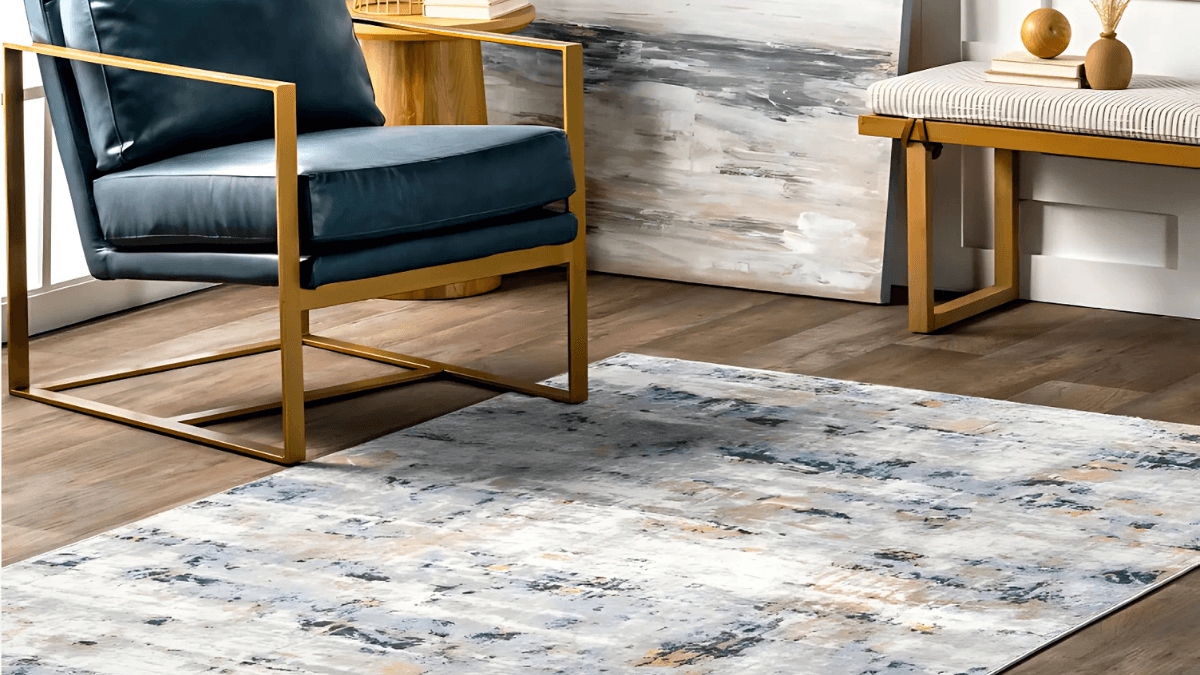 Modern abstract area rug with subtle tones of gray, beige, and hints of blue, perfect for enhancing a minimalist living space.