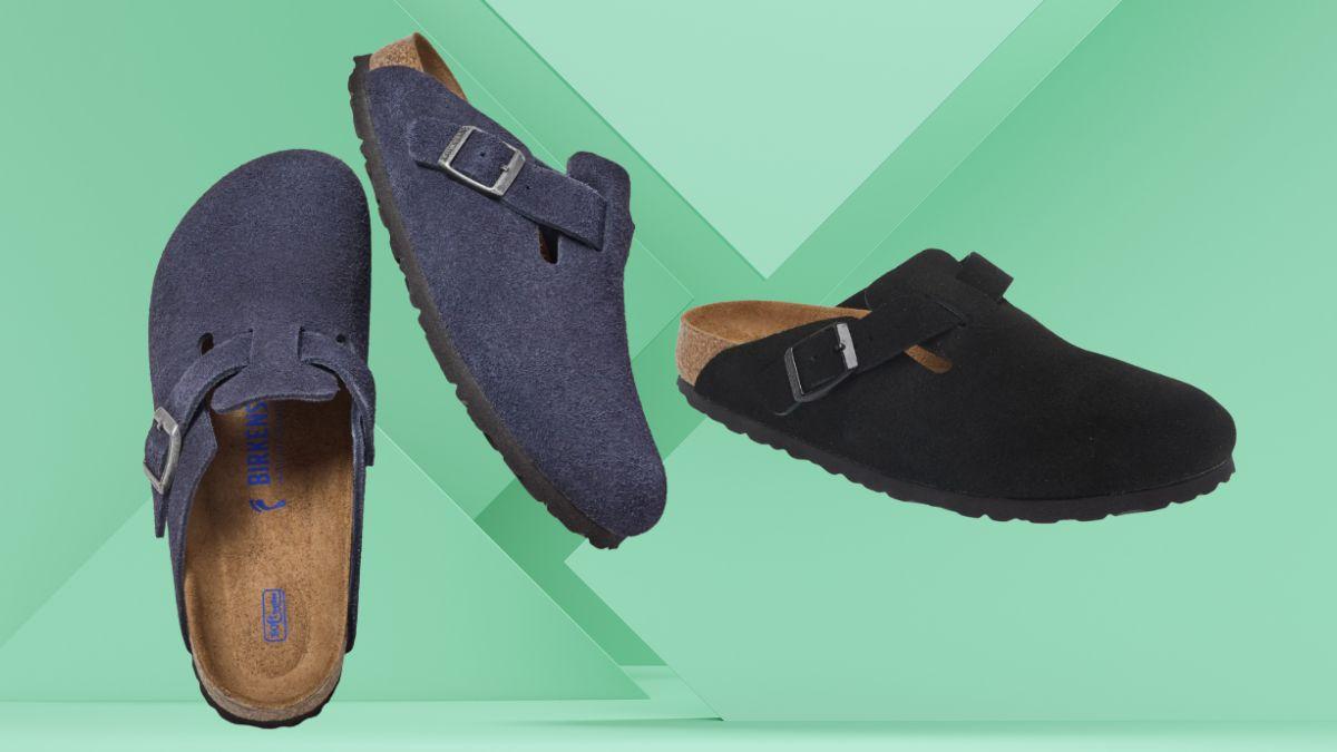 Two suede clogs in navy and black with buckle straps displayed against a green background.