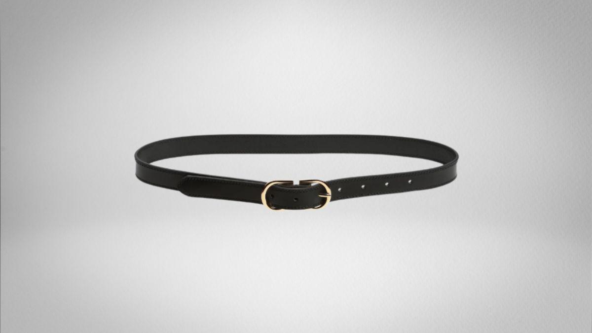 A black leather belt with a gold buckle, laid flat on a plain background.