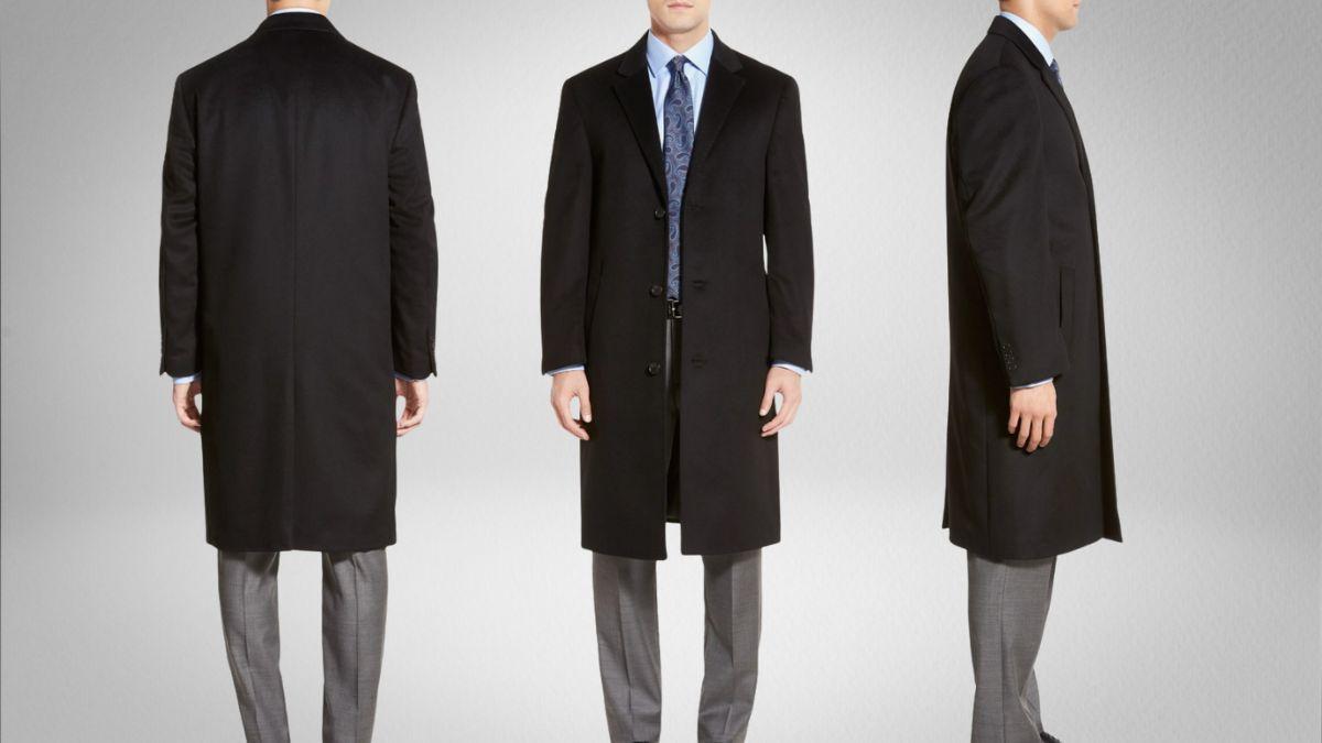 A man wearing a classic black overcoat, shown from the front, back, and side to highlight its fit, length, and tailored design against a neutral background.