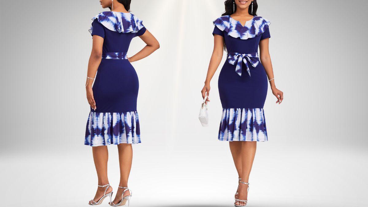 A woman wearing a navy blue ombre bodycon dress with short sleeves, a belted waist, ruffled neckline, and a flared hem.