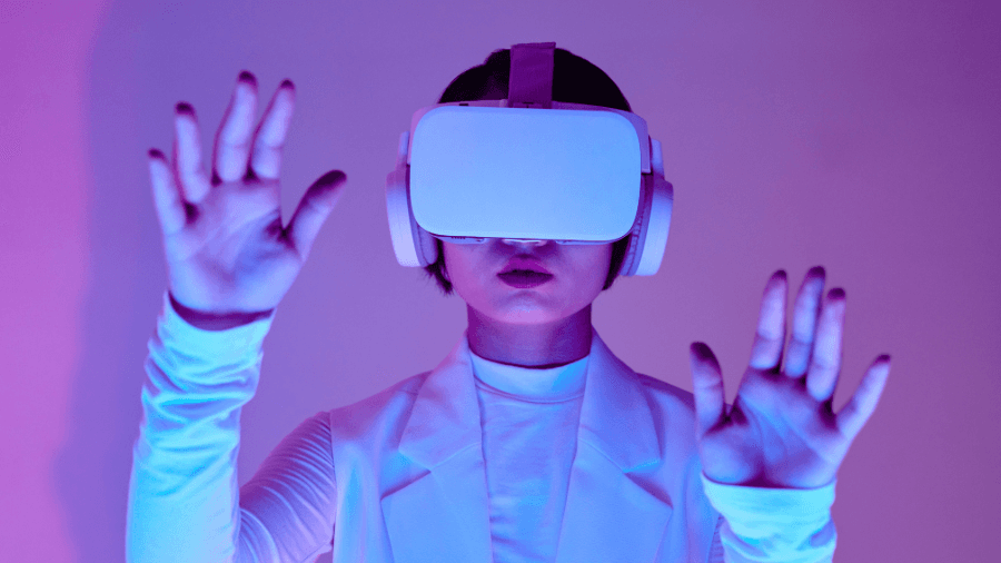 A woman wearing a VR headset, immersed in a virtual experience, with a neon-lit background.