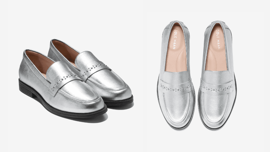 A pair of metallic silver loafers with perforated detailing and a black sole, shown from a side and top view against a white background.