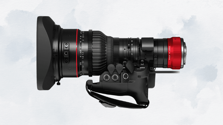 A professional cinema camera lens with a large hood, precision focus and zoom rings, and a red metallic mount, designed for high-end video production.