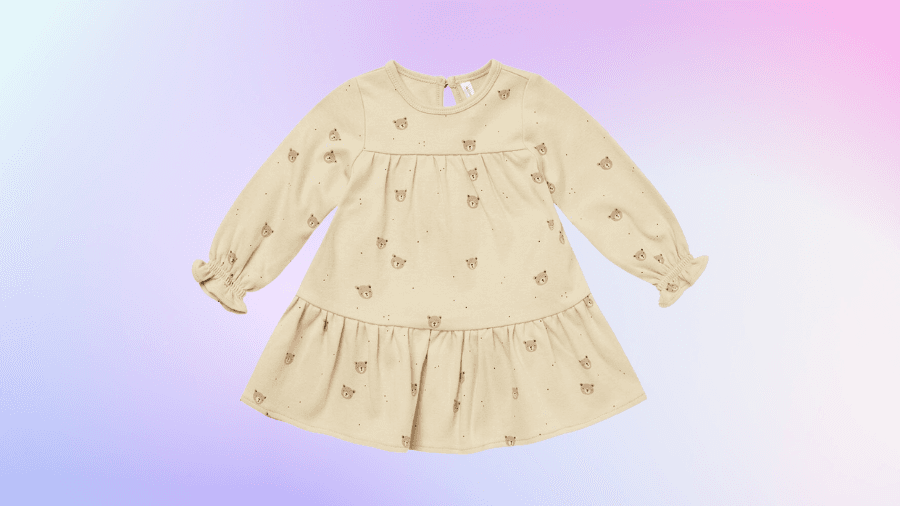 Beige long-sleeve dress with a bear print on a pastel gradient background.