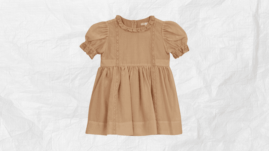 Light brown short-sleeve dress with ruffle details on a textured white background.