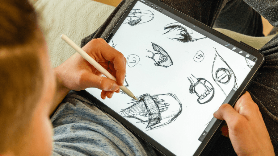 Person drawing product sketches on a tablet using a stylus.