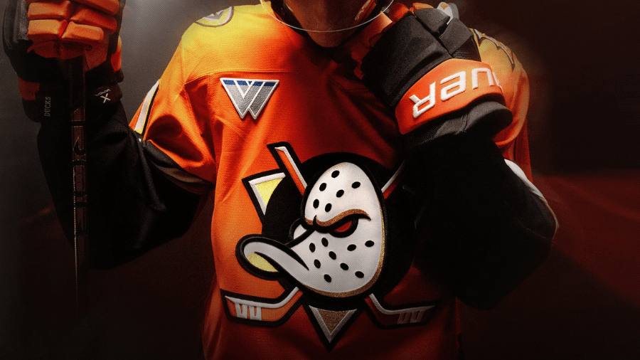 Close-up of a hockey player wearing an orange Anaheim Ducks jersey featuring the iconic Wild Wing logo.