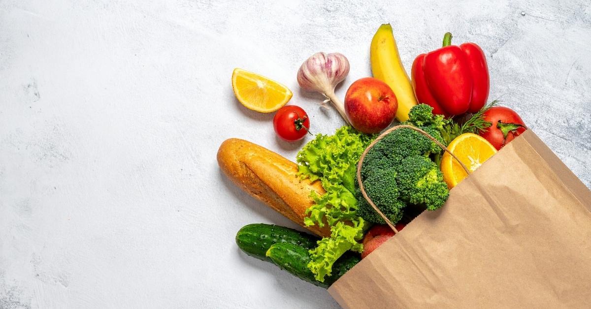 Paper grocery bag with fresh produce, bread, and fruit for DoorDash Grocery delivery